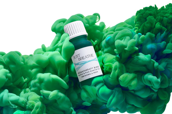 Just breathe aromatherapy blend of pure essential oils and menthol from Elan Skincare in green 10 ml bottle and a green abstract cloud