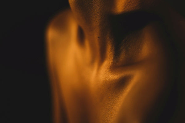 Décolletage glowing in gold, woman body 