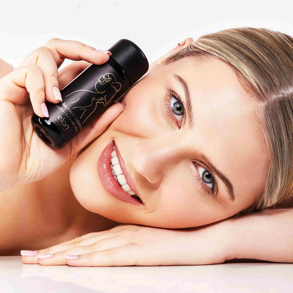 Wonder Face Cleanser from Elan Skincare being held by a young beautiful woman